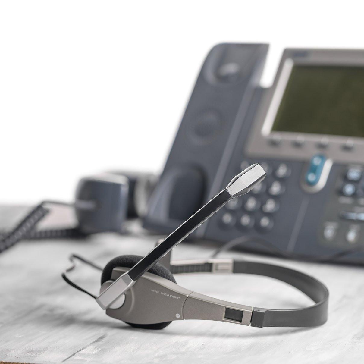 VOIP headset headphones telephone on office desk concept for communication, it support, call center and customer service help desk. Business center background, phone support service calls.